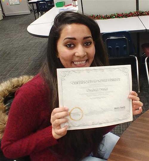 student holding certificate 